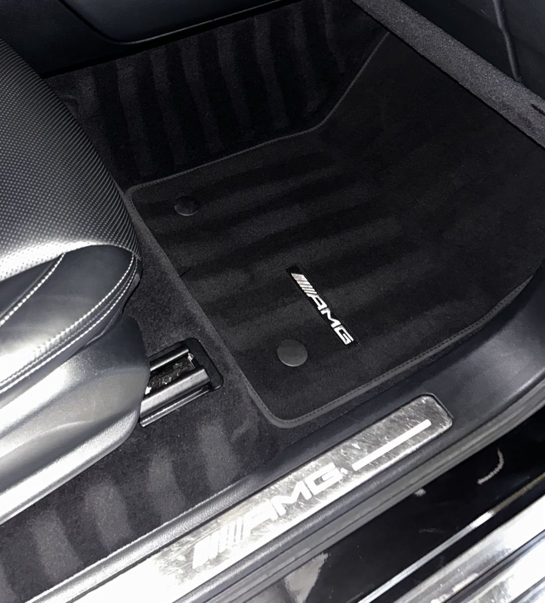 Black AMG floor mat and carpet with fresh vacuum lines