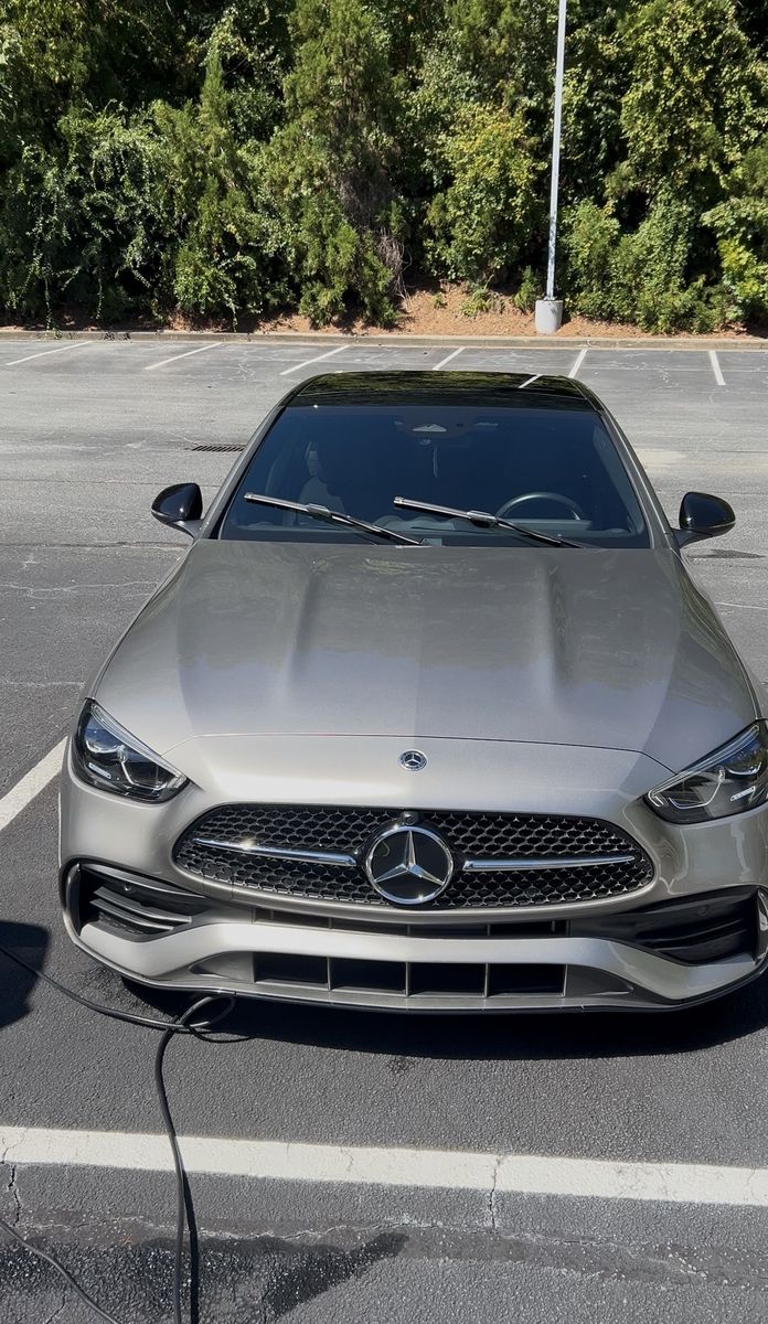 Champagne Mercedes C-Class detailed on site in a parking lot