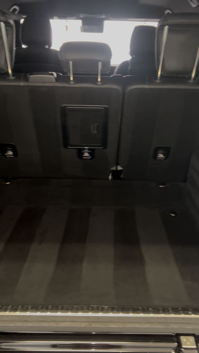 SUV cargo area vacuumed clean with visible carpet lines