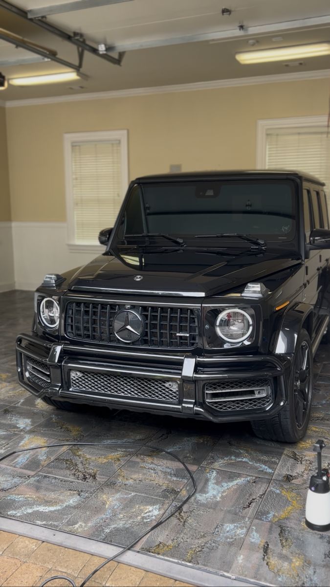 Black Mercedes G-Class detailed inside a home garage